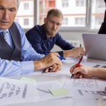 business-people-discussing-charts-graphs-table-meeting